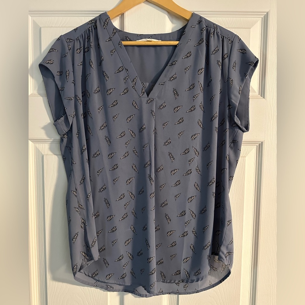Blue top with black and white feather pattern